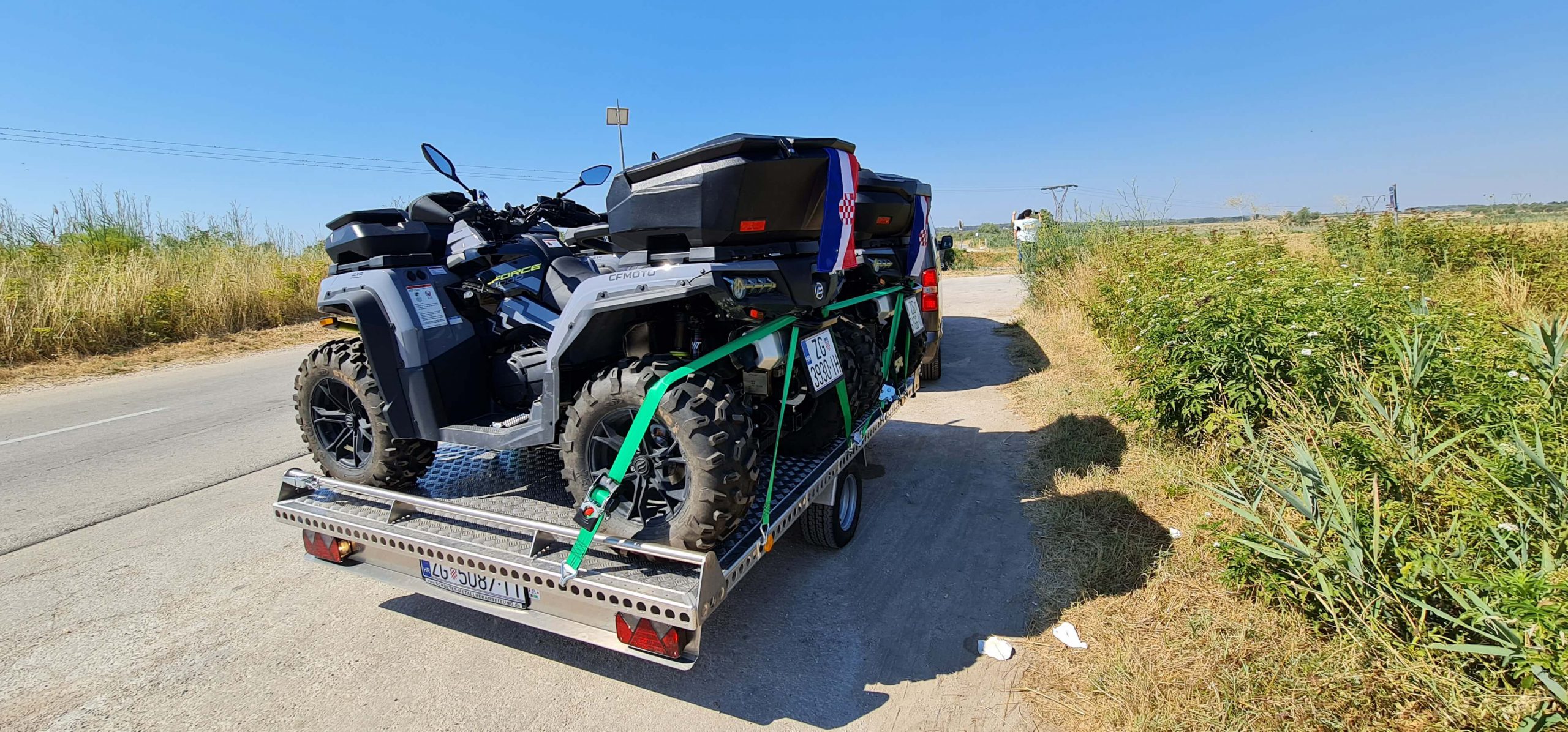 zwei Quads auf Aluminium Plattformanhänger auf einer Straße