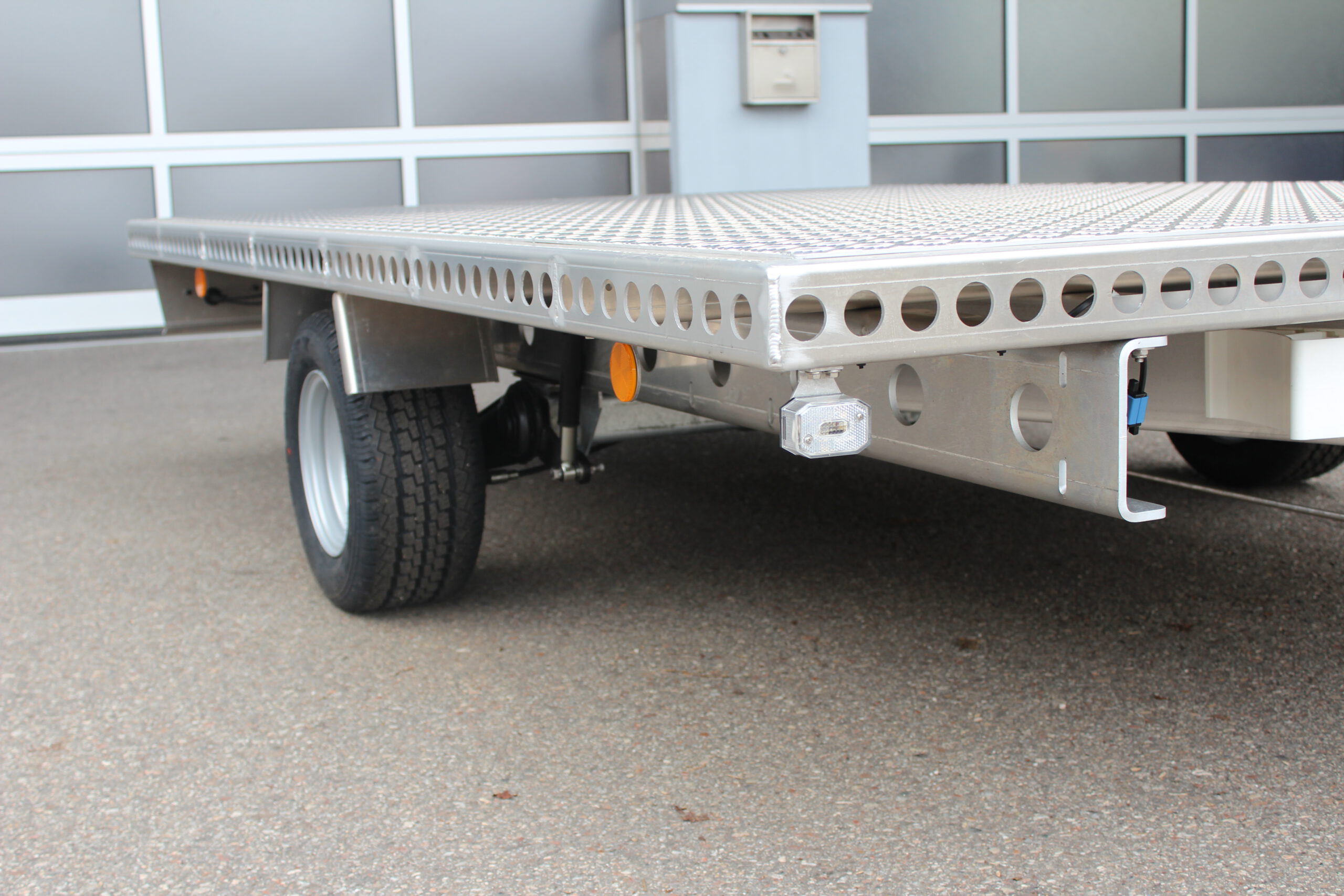 Aluminium Plattform-Anhänger 3,0m x 2,0m vor einem Hallentor